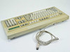 BTC 5339R-0 AT Keyboard – rear three-quarter view showing coiled DIN 5-pin connector cord and yellowed case