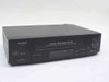 Sharp VC-A410U 4-Head VHS VCR — front three-quarter view showing cassette door and control panel