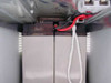 APC SU24XLBP interior view with battery compartment open showing red and black wiring harness — old batteries removed