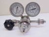 Pacific Scientific 2653 stainless steel high-pressure regulator front view showing dual pressure gauges, black adjustment knob, and AN male inlet fitting