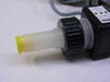 Omega FTB604 flow meter close-up of barbed inlet fitting with yellow protective end cap and sensor body label