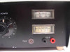 Close-up of front panel right side – AC Volts meter (0-300V scale), DC Amperes meter (0-5A scale), FAN multi-pin connector, black and red COIL banana binding posts