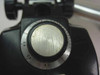 Close-up of zoom/magnification dial showing scale markings from 0.7 to 1 with surface wear on the dial face