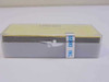 Ushio USH-102DH 100W mercury arc lamp in original clear plastic protective case — side view showing foam cushioning and Ushio Inc label