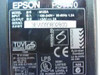 Epson PS-170 M122A rating plate showing model M122A, 100-240V input, 24VDC 2A output, UL/CE/TUV certifications