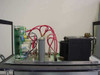 Amray 124-002 Ion Pump Power Supply — internal side view showing PCB, cylindrical HV capacitor, transformer, and red interconnect wiring