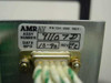 Amray 124-002 label closeup — shows PN 124-002, Assembly Number 91107D, Date MFD 10-90, Rev E2, with DB-9 control connector and wiring harness visible