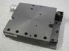 AeroTech ATS-301 linear stage top view showing 5x5 inch black anodized aluminum tabletop with mounting holes and micrometer knob