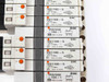 SMC solenoid valve label close-up — multiple VQ1100-5 and VVQ1000-10A-1 valve labels visible on right-center section of manifold