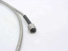 Close-up of second SMA male connector on semi-rigid coaxial cable showing center pin, threaded nut, and braided-to-black-jacket transition