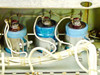 RCA MI-560772 Raw DC Power Supply — close-up of three large blue electrolytic filter capacitors mounted in a row with white wiring