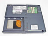 NEC Versa LXi VM4FBEA – bottom opened showing empty hard drive bay with ribbon cable, empty RAM slots (SO-DIMM), and bottom label with model and Windows 98 SE COA sticker