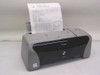 Canon PIXMA iP1500 inkjet printer front view with Windows XP test page printing from paper tray