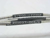 Close-up of black heat-shrink cable label printed with part number 201037-005/A on two of the semi-rigid coaxial cables