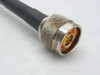 Second N-type male connector end of Times Microwave LMR-400 coaxial cable showing gold center pin and knurled silver body
