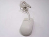 Microsoft 63607 PS/2 wired mouse — right-side profile view showing beige body and coiled PS/2 cable