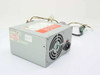 Power Tronics SK-4145DE 145W AT switching power supply — angled front view showing fan, IEC inlet, and output harness