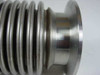 Close-up of MKS HPS vacuum bellows corrugated convolutions and smaller flange end showing surface discoloration