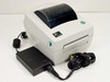 Zebra LP2844 direct thermal label printer – right-side front view with external power supply and power cable