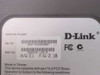 D-Link DI-604 bottom label showing model number DI-604, serial number, MAC address, hardware version E1, firmware 2.18, and FCC markings