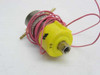 Clippard EVO-3 Minimatic solenoid valve rear/bottom view showing yellow coil housing, threaded port, brass barbed fittings, and pink lead wires