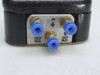 Close-up of Linemaster 4C-30F2-S port panel showing one IN port and two OUT N.O. push-in fittings on cast iron base