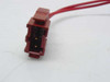 Red DIN-style wiring connector on ASCO 8320A47 solenoid valve — closeup showing gold contacts and connector body