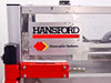 Hansford Automation Systems logo plate on the machine frame – close-up showing brand name and red/gold diamond logo