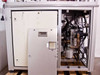Lower base cabinet interior – left door open showing enclosed panel side; right bay open showing hydraulic/pneumatic plumbing, regulator, and wiring