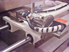 Shuttle carriage close-up – showing label marked A-120, pneumatic fittings with push-to-connect tubing, sensor, and linear rail mounting