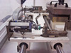 Linear rail and boat fixture end view – showing pneumatic cylinder, proximity sensor, shuttle slide assembly, and tooling platen with guide posts