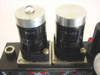 Close-up of two cylindrical solenoid valves on the manifold block, marked R402 (left) and R451 (right), Made in USA label visible on base