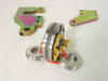INA ZARF 2575 LTN bearing assembly with needle roller cage, two thrust washers, red retainer clip, and yellow protective wrap — two zinc-chromate mounting brackets in background