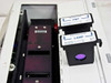 Dynatech Fluorolite 1000 – filter cartridges removed showing Emission Filter (PMT) cartridge and Excitation Filter (LAMP) cartridge with visible optical filter element