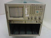 Tektronix 7854 oscilloscope — direct front view showing CRT screen with graticule, full front-panel button and knob layout, lower mainframe chassis with four empty plug-in bays visible