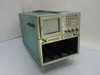 Tektronix 7854 waveform processing oscilloscope mainframe — three-quarter front-left view showing CRT display, front panel controls, and empty lower plug-in chassis with four vacant slots
