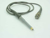 Tektronix S-265 oscilloscope probe with needle tip exposed, gray body, and BNC connector at cable end — side profile view