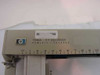HP 7046A nameplate closeup reading '7046A X-Y RECORDER HEWLETT PACKARD' with HP logo badge and ruler scale