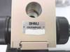 Close-up of Olympus BHMJ focusing stage nameplate — 'BHMJ OLYMPUS' engraved metal badge with circular optical port visible