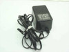 Epson PB-6509 AC adapter full view showing black housing and coiled power cord with 4-pin Mini-DIN output connector