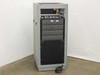 Advanced Microtechnology burn-in rack side view showing card cage slots, multiple plug-in card ejector handles, and power cable