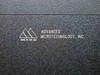 Close-up of Advanced Microtechnology Inc. embossed logo plate on burn-in system cabinet — Made in the USA