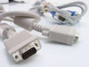 Close-up of the beige VGA cable's 15-pin male HD15 connector in the foreground, with the blue-connector cable visible in background
