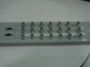 Nortel NTFP99AB DS3/E3 3-Channel Sparing Panel – rear view showing full array of BNC connectors in two rows, two DB9 ports on left side, and two green LED indicators
