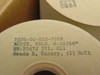 Close-up of teletype paper roll label showing NSN 7530-00-223-7966, PAPER TELE 8-25/64, spec UU-P547J TY1 CL1, Grade B Canary