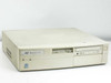 AST Bravo MS P/100 desktop front-right view showing full unit with 3.5-inch floppy drive, CD-ROM drive, and power button
