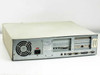 AST Bravo MS P/100 rear panel view showing PSU fan, IEC power inlet, red power switch, expansion slots, serial, parallel, and VGA ports