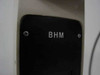 Close-up of Olympus BHM model nameplate — BHM designation in white text on black panel