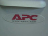 APC logo closeup on the UXBP24 Ultra Battery Pack enclosure — oval APC sticker on grey housing
