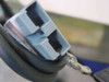 APC UXBP24 grey battery connector closeup — dual-position grey locking connector on black cable